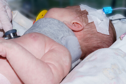 Newborn baby is checked by doctors