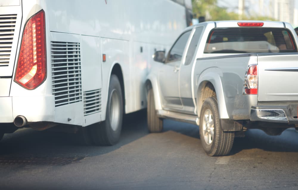 a crash between a pickup and a bus