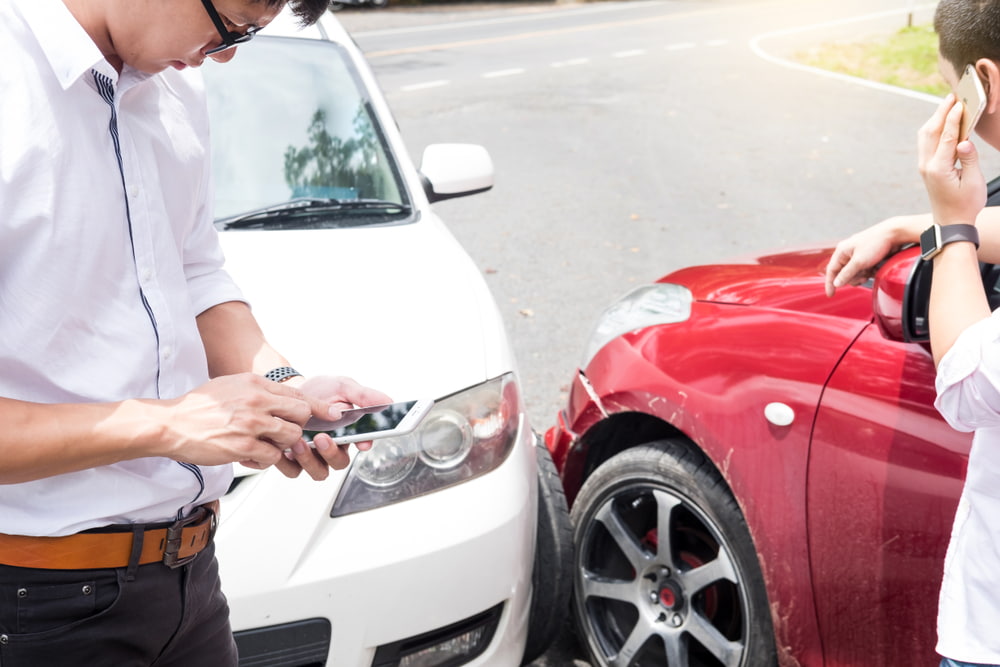 man calling insurance after car accident