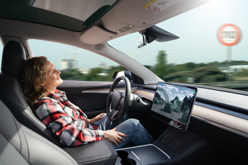 woman rests while her car drives itself