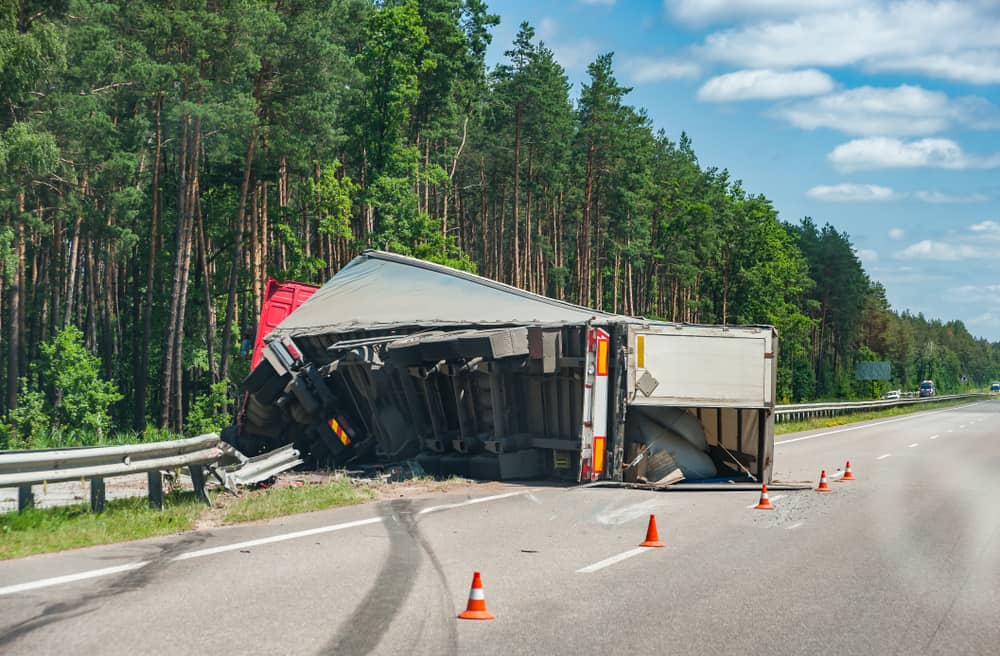 Truck overturned on the road after colliding with a car