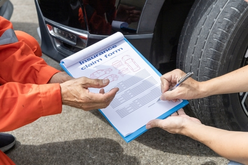 Insurance agent signing a claim with the affected client