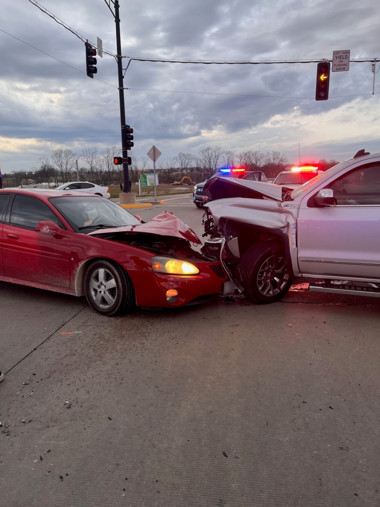 car accident scene with red sedan crashed into by silver SUV or truck